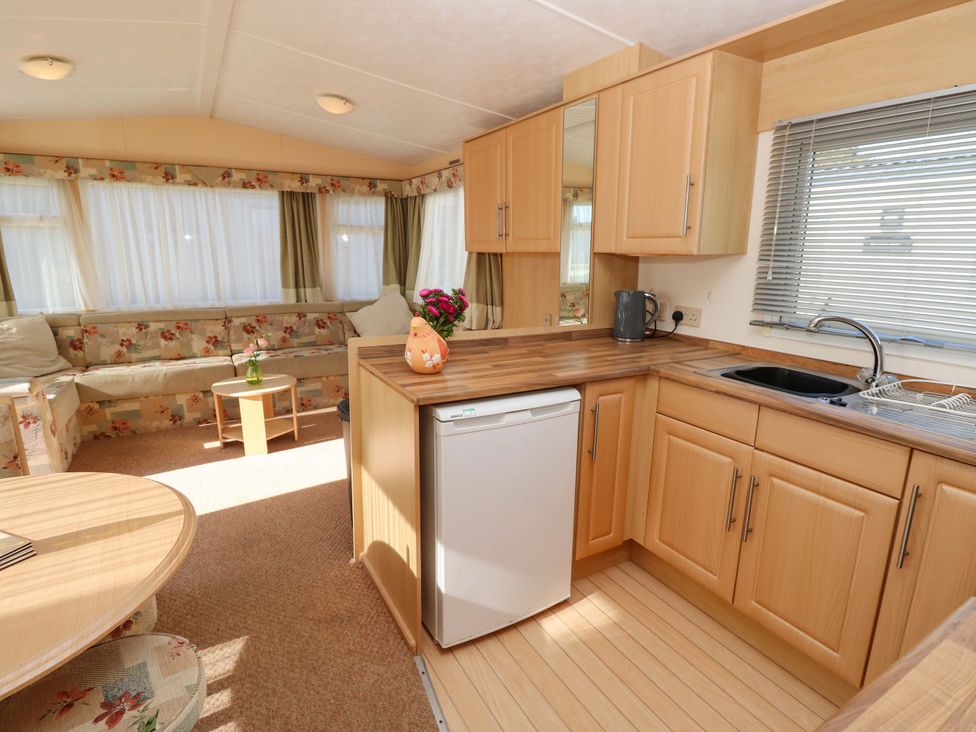 A living room with a kitchen area and dining table at Number 38 in Chichester