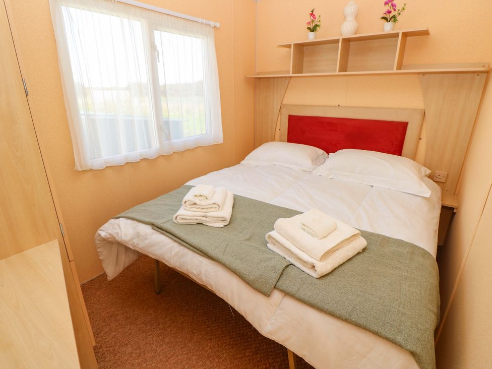 A bedroom with a bed and window at Number 38 in Chichester
