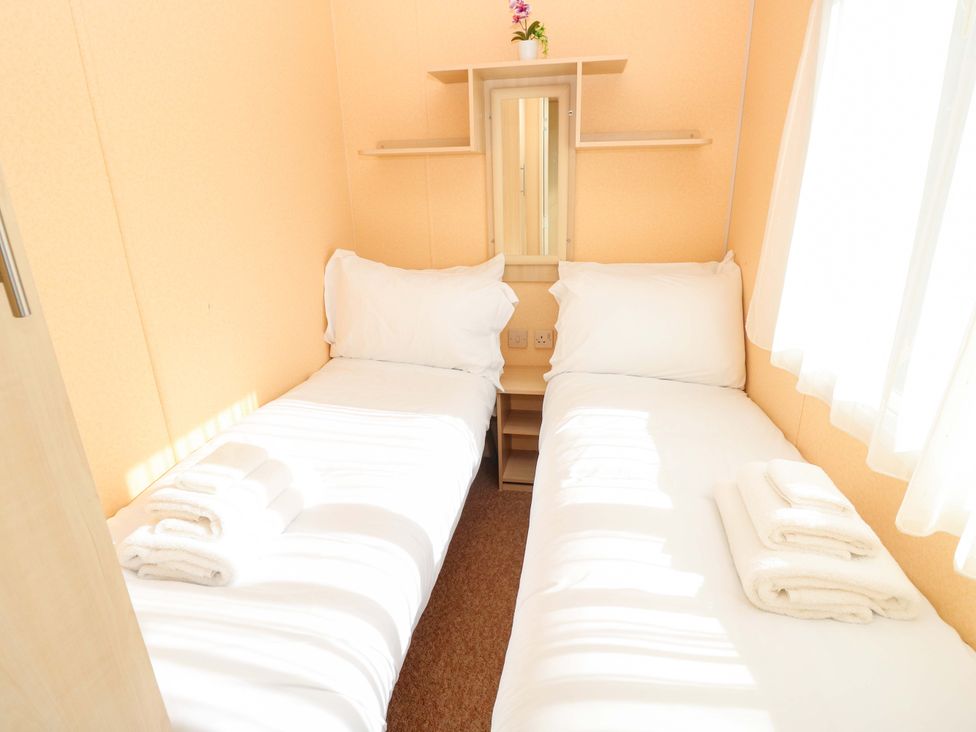 A bedroom with two single beds and a mirror at Number 38, Chichester
