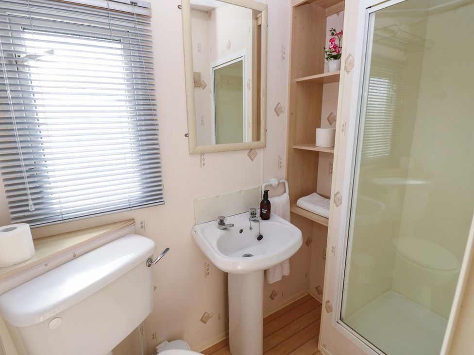 A bathroom with a sink, toilet, and shower at Number 38 in Chichester