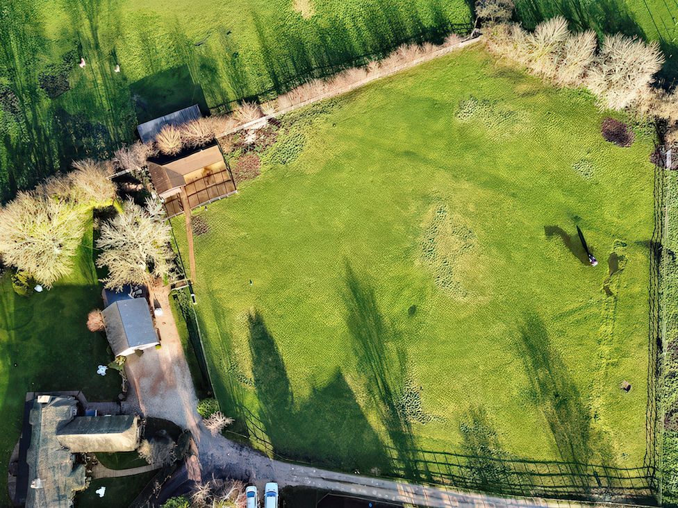 An aerial view of a garden area with a shed and trees at Lake Cottage in Swindon