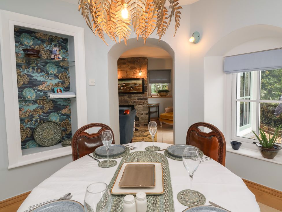 A dining room with a table set for dining at Rookery Cottage in Lynton