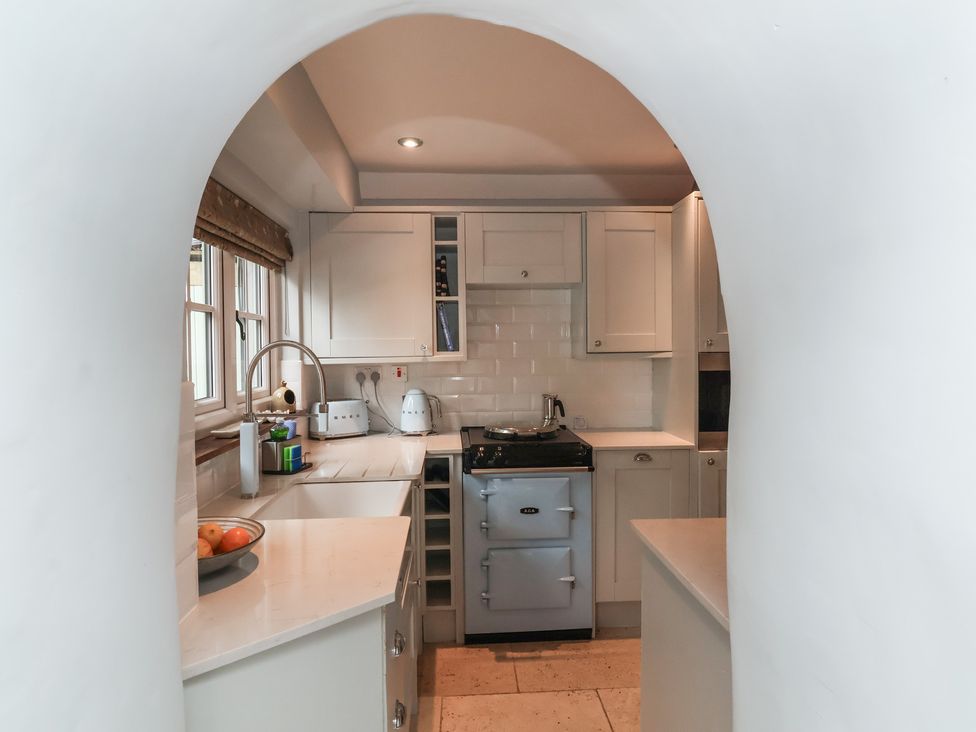 A kitchen with cabinets and a stove at Rookery Cottage in Lynton