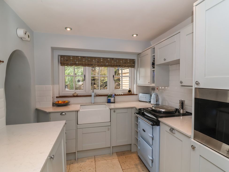 A kitchen with a sink and cooker at Rookery Cottage in Lynton