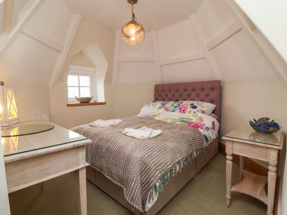 A bedroom with a bed and bedside table at Rookery Cottage in Lynton
