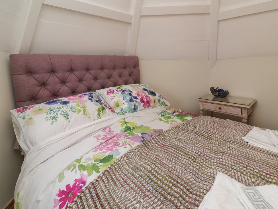 A bedroom with a bed and side table at Rookery Cottage in Lynton