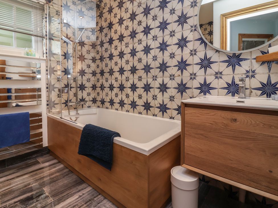 A bathroom with a bathtub and sink at Rookery Cottage in Lynton