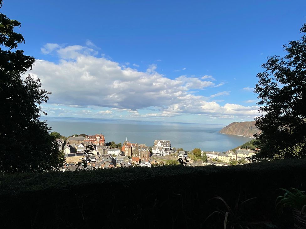 A view of the ocean and buildings at Rookery Cottage in Lynton