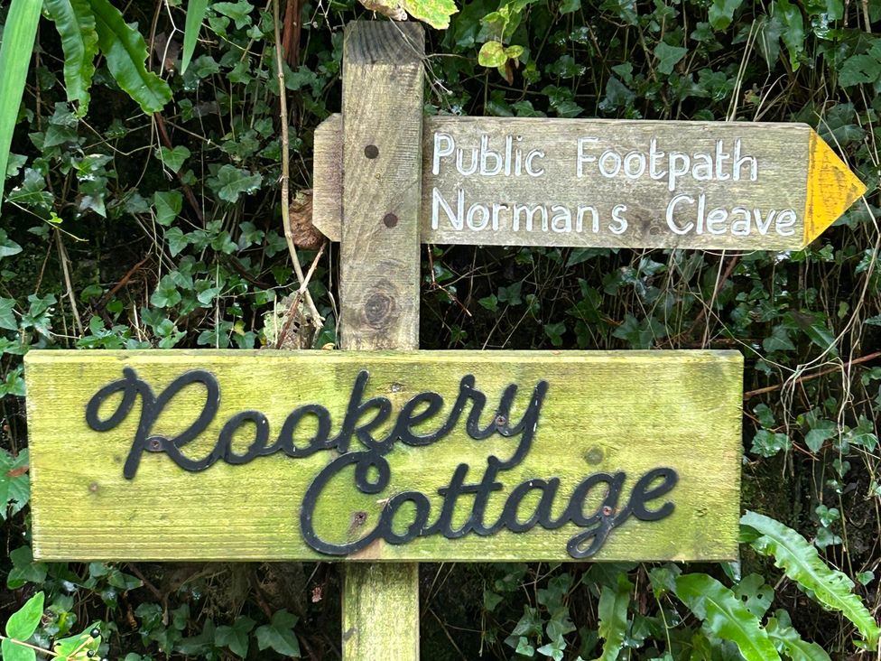A wooden sign indicating Rookery Cottage and a public footpath near Lynton