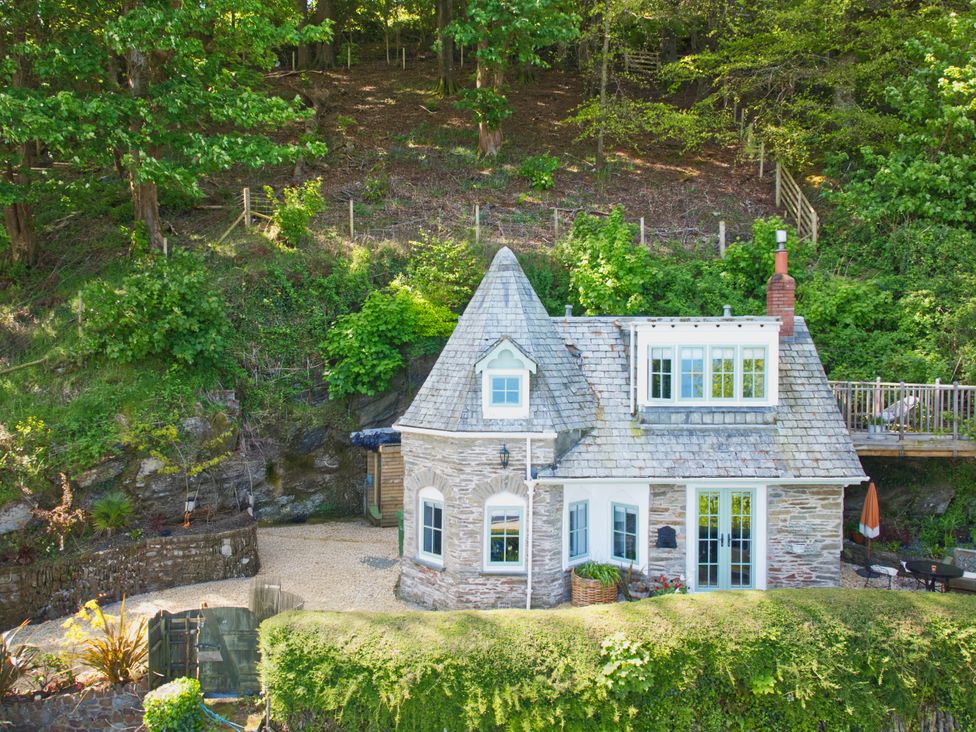 A cottage surrounded by trees and garden at Rookery Cottage in Lynton