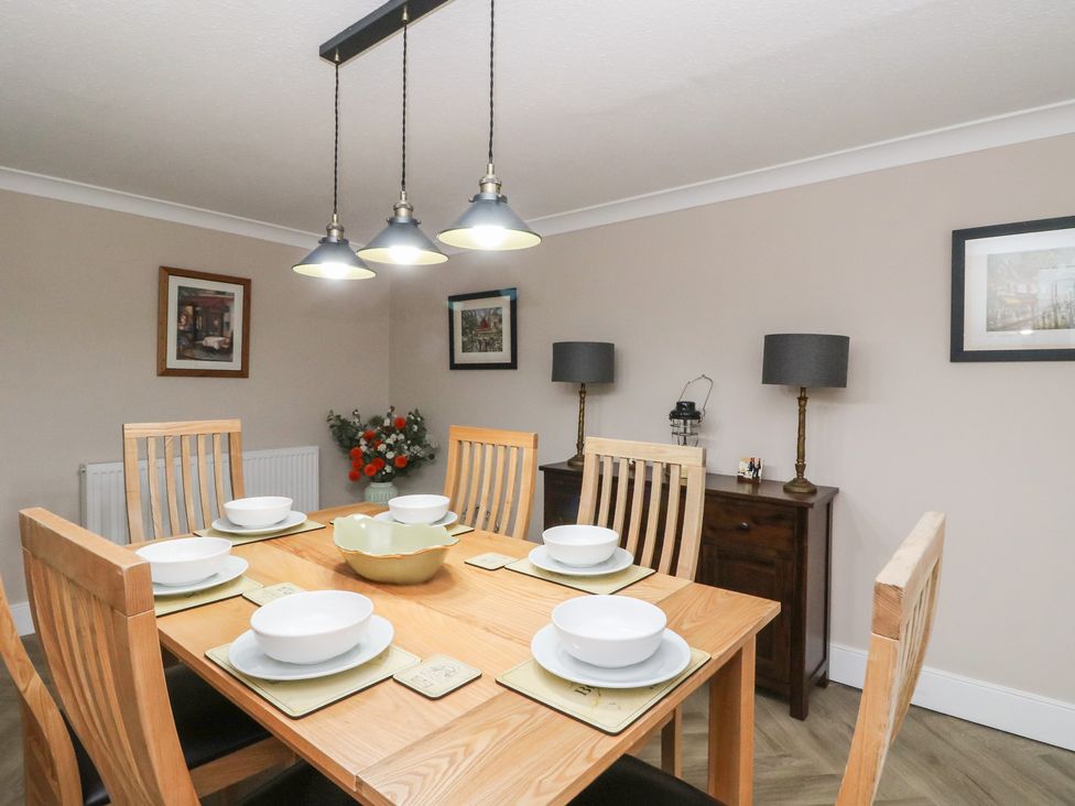 A dining room with a table set for meals at Pirnie's in Pitlochry