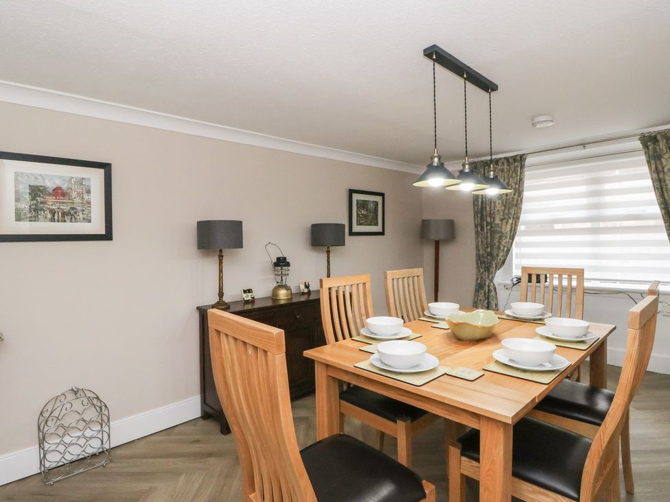 A dining room with a table set for dinner at Pirnie's in Pitlochry