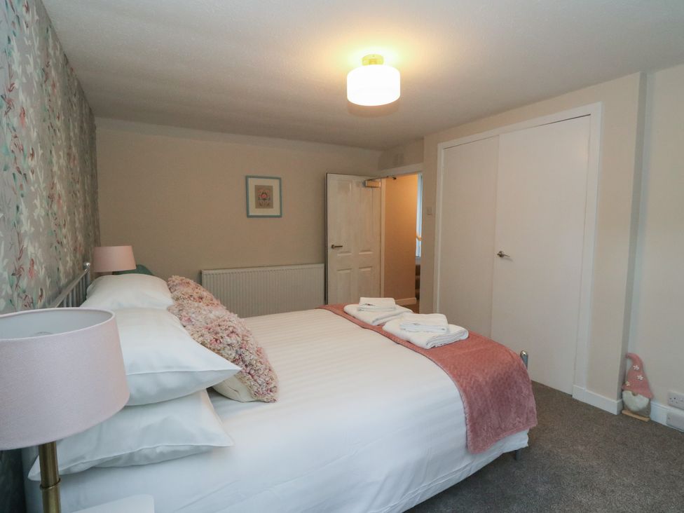 A bedroom with a bed and lamp at Pirnie's in Pitlochry