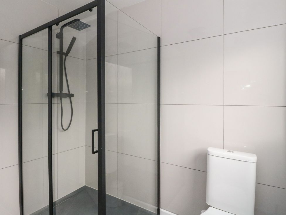 A bathroom with a shower and toilet at Pirnie's in Pitlochry