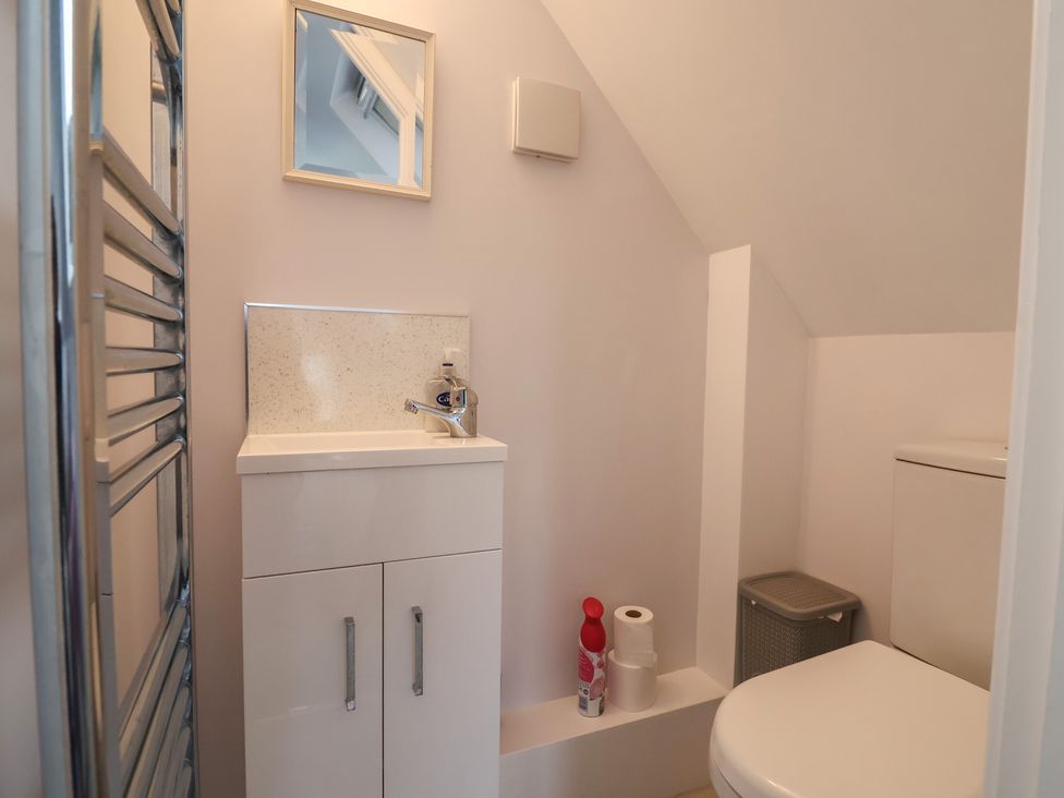A bathroom with a sink and toilet at Cherry Pip in Charmouth