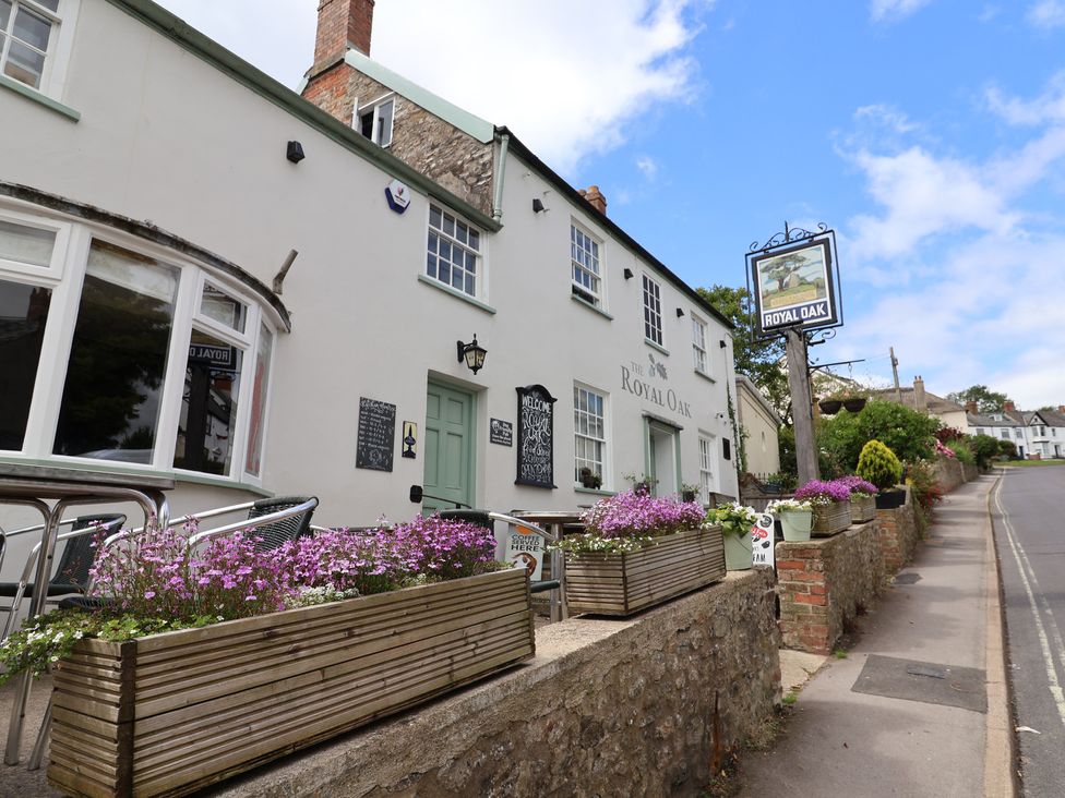 A pub exterior with flower planters at The Royal Oak in Charmouth