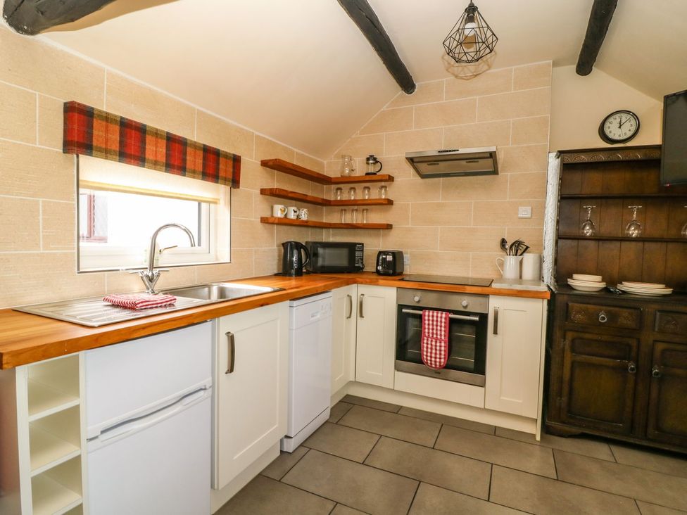 A kitchen with appliances and storage at 1 Small in Malton