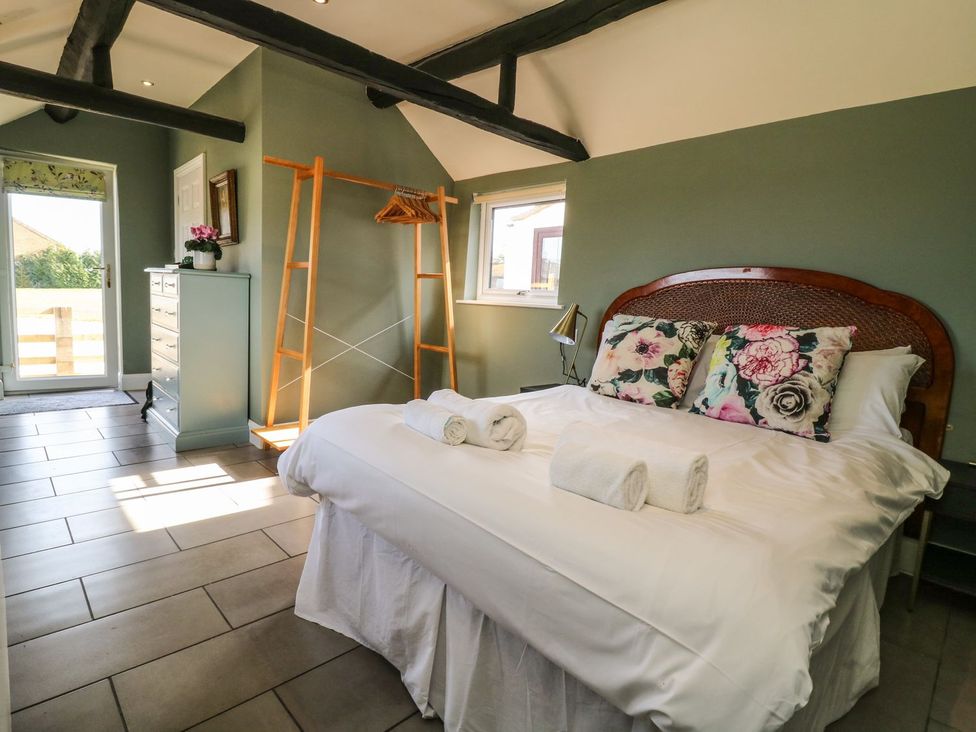 A bedroom with a bed and dressing table at 1 Small in Malton