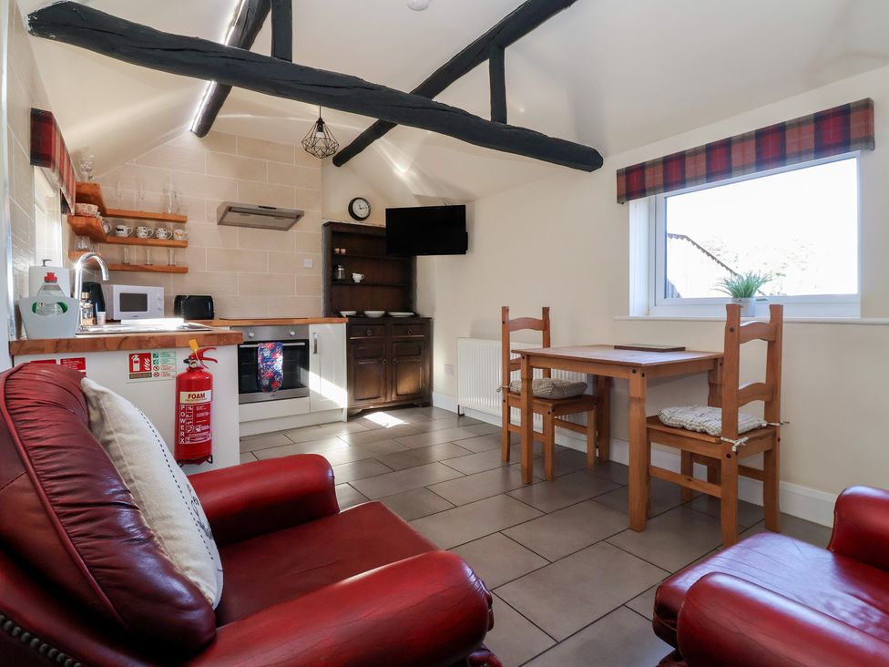 A kitchen with seating and appliances at Cowshed Cottage East Knapton near Rillington