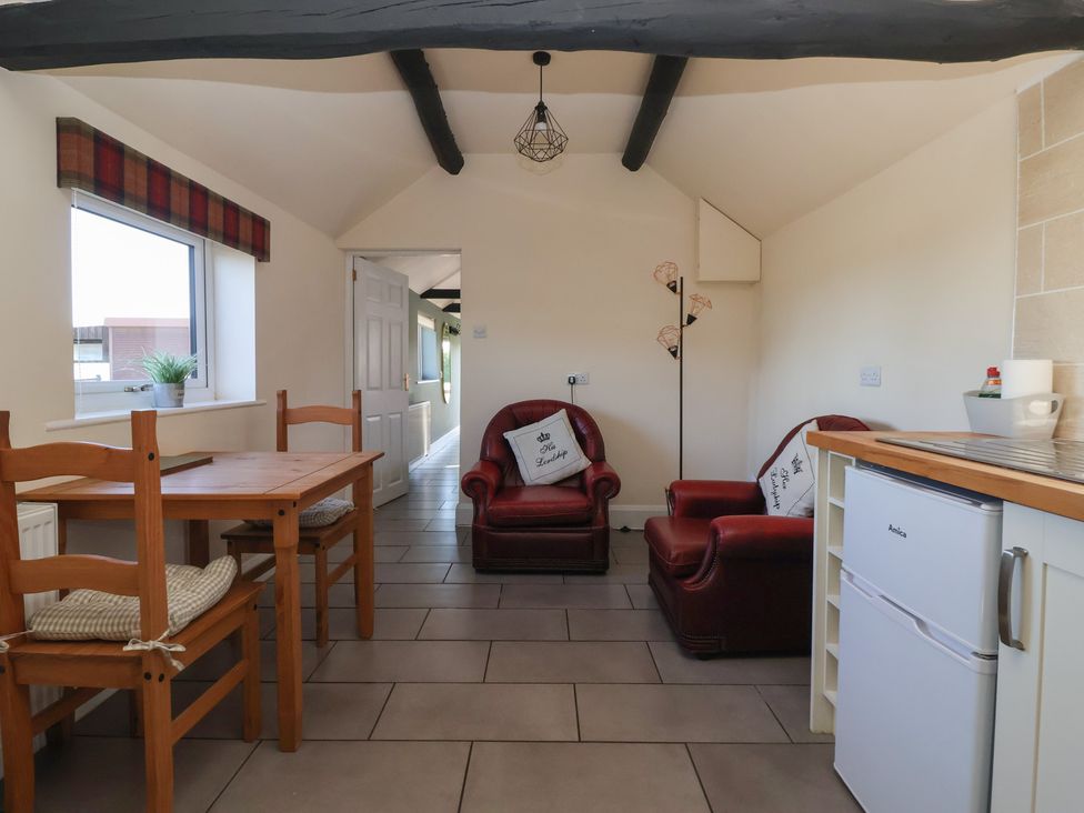 A kitchen with a table and chairs at Cowshed Cottage East Knapton near Rillington