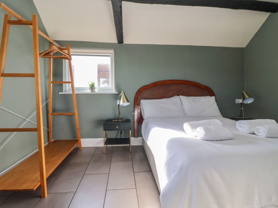 A bedroom with a bed and nightstand at Cowshed Cottage East Knapton near Rillington