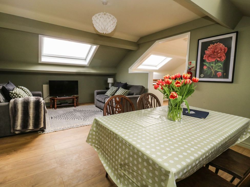 A living room with a sofa and television at 2 Jade side in Malton