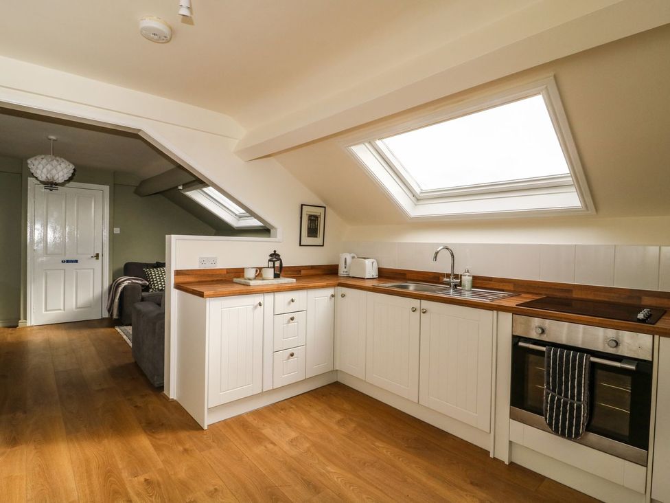 A kitchen with wooden countertop and skylight at 2 Jade side in Malton