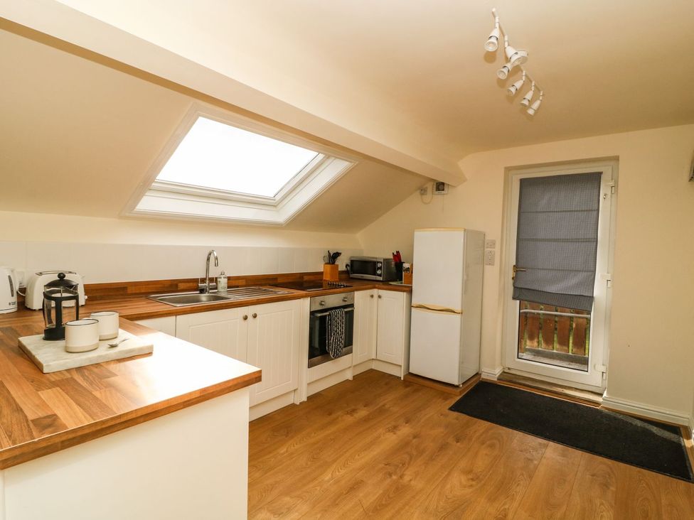 A kitchen with refrigerator and sink at 2 Jade side in Malton