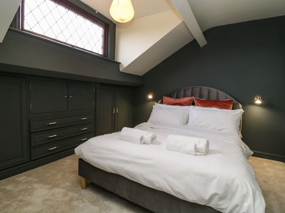 A bedroom with a bed and wardrobe at 2 Jade side in Malton