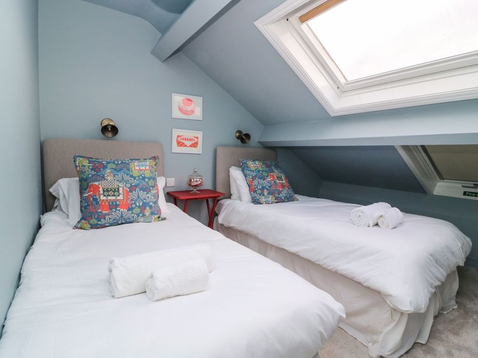 A bedroom with two single beds and decorative pillows at 2 Jade side in Malton