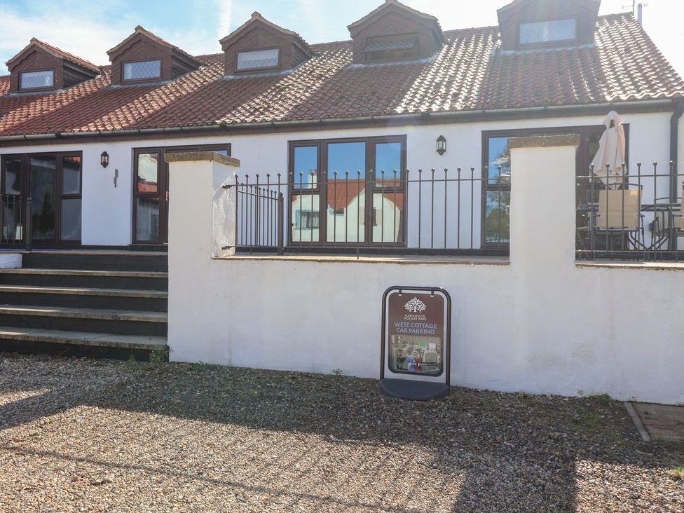 An outdoor area with a cottage, steps and a parking sign at East Cottage East Knapton near Rillington