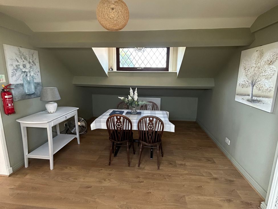 A dining room with a table and chairs at West Cottage in East Knapton near Rillington