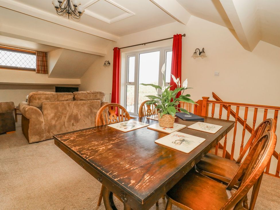 A dining room with a table and chairs at 3 Marinas side Malton
