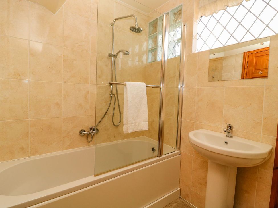 A bathroom with a shower and a bathtub at 3 Marinas side Malton