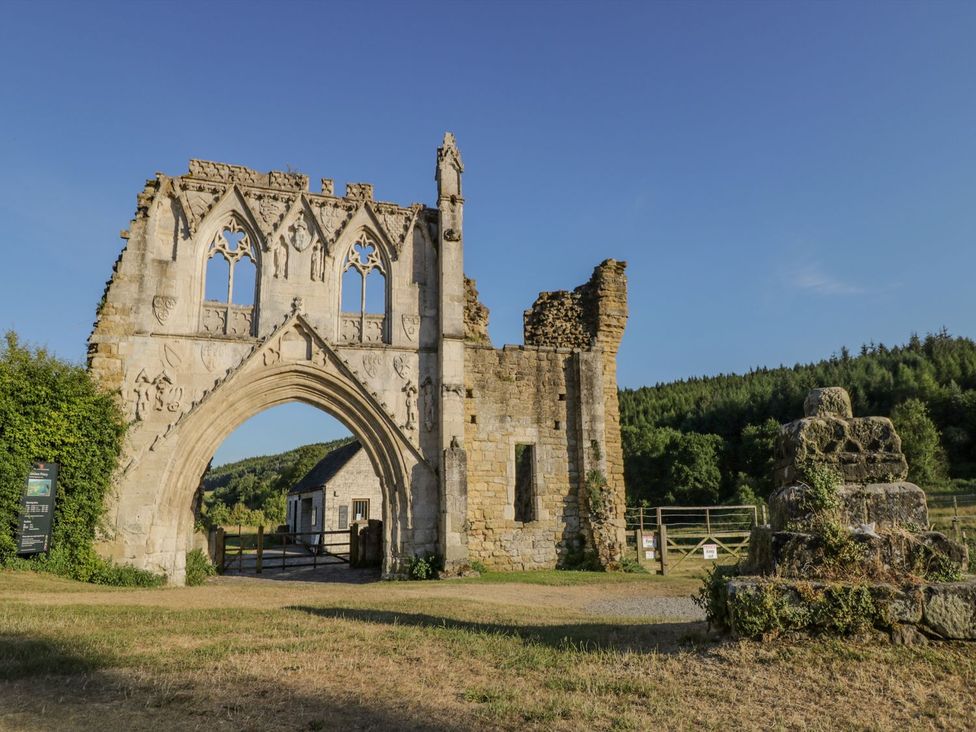A stone archway ruin surrounded by greenery at 3 Marinas side Malton