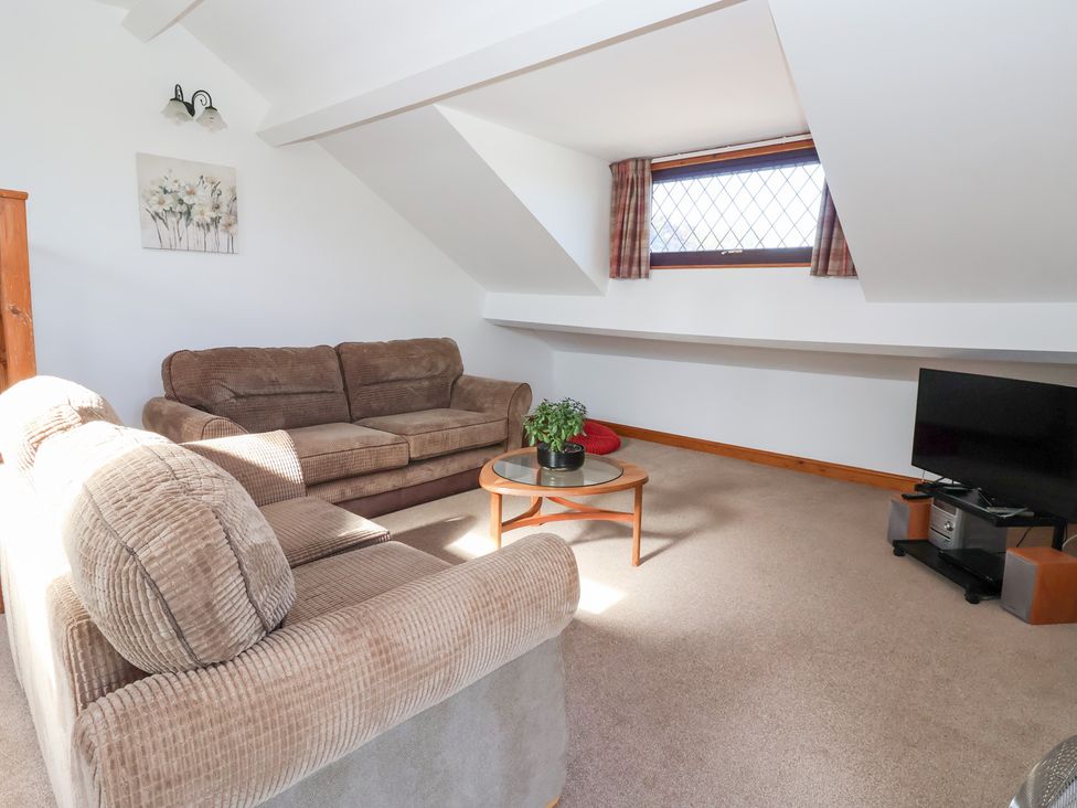 A living room with a sofa and television at West Cottage in East Knapton near Rillington