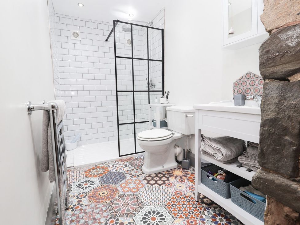 A bathroom with shower, toilet, and sink at 8 Watkin Street in Conwy