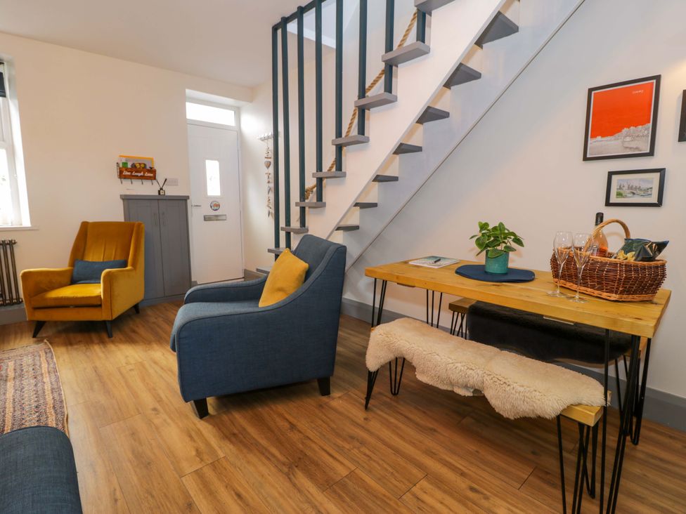 A living room with armchairs and a table at 8 Watkin Street, Conwy