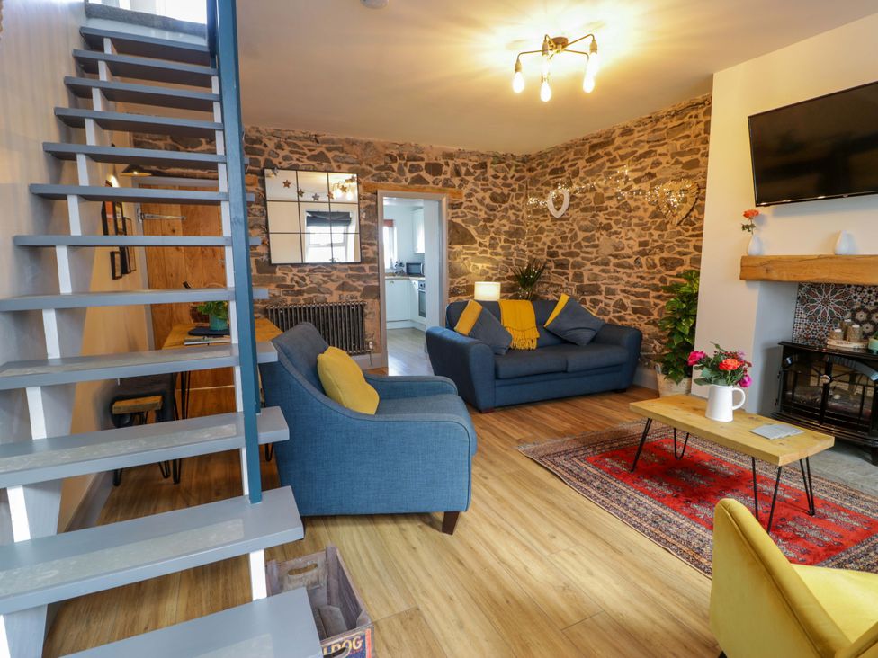 A living room with a sofa and coffee table at 8 Watkin Street Conwy