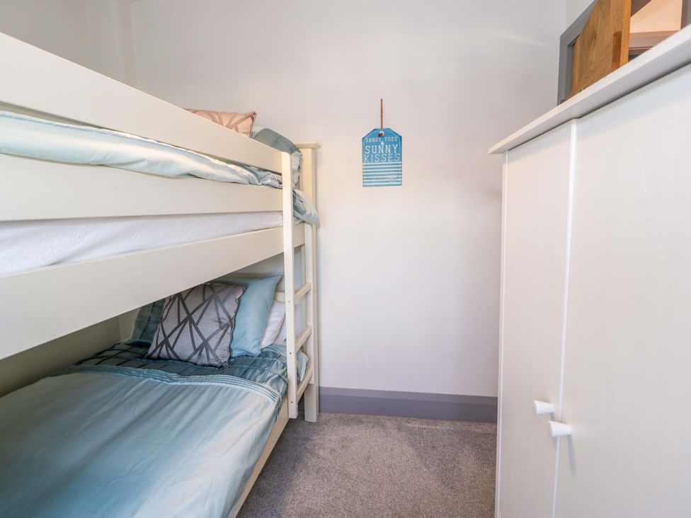 A bedroom with a bunk bed and a wardrobe at 8 Watkin Street, Conwy