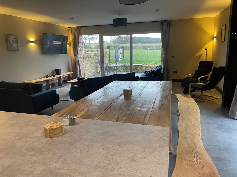 A living room with a table and sofas at Spring Meadow in Croxdale