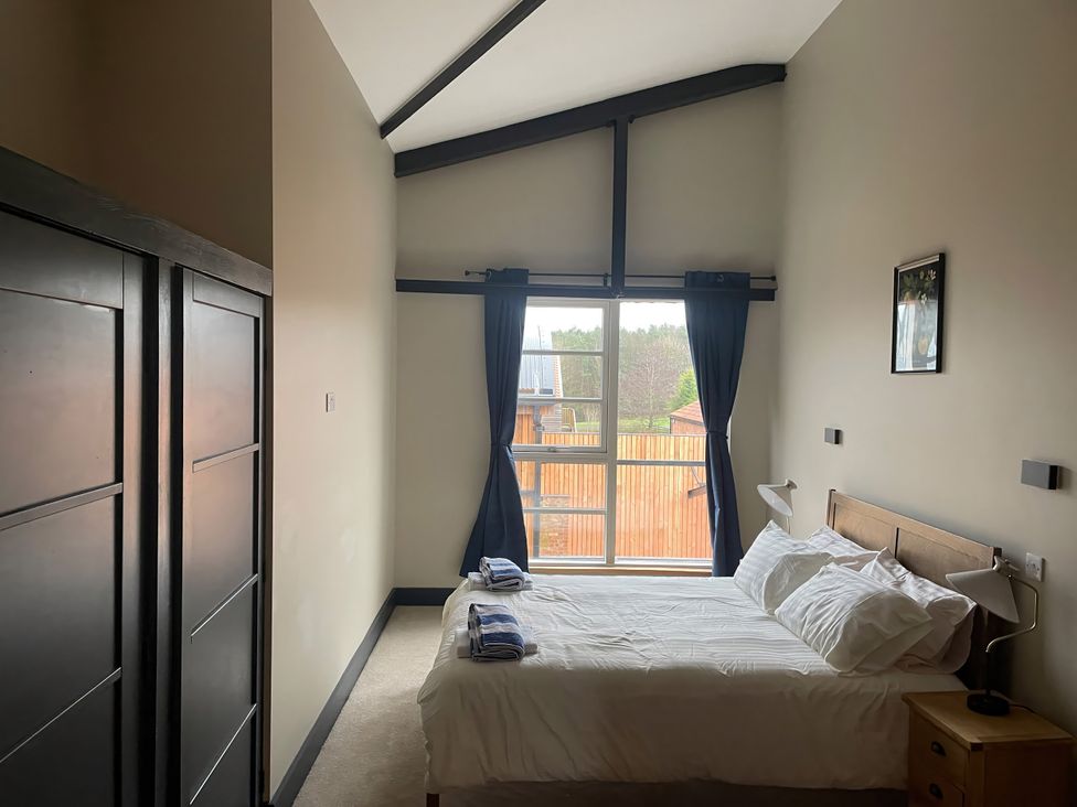 A bedroom with a bed and wardrobe at Spring Meadow in Croxdale