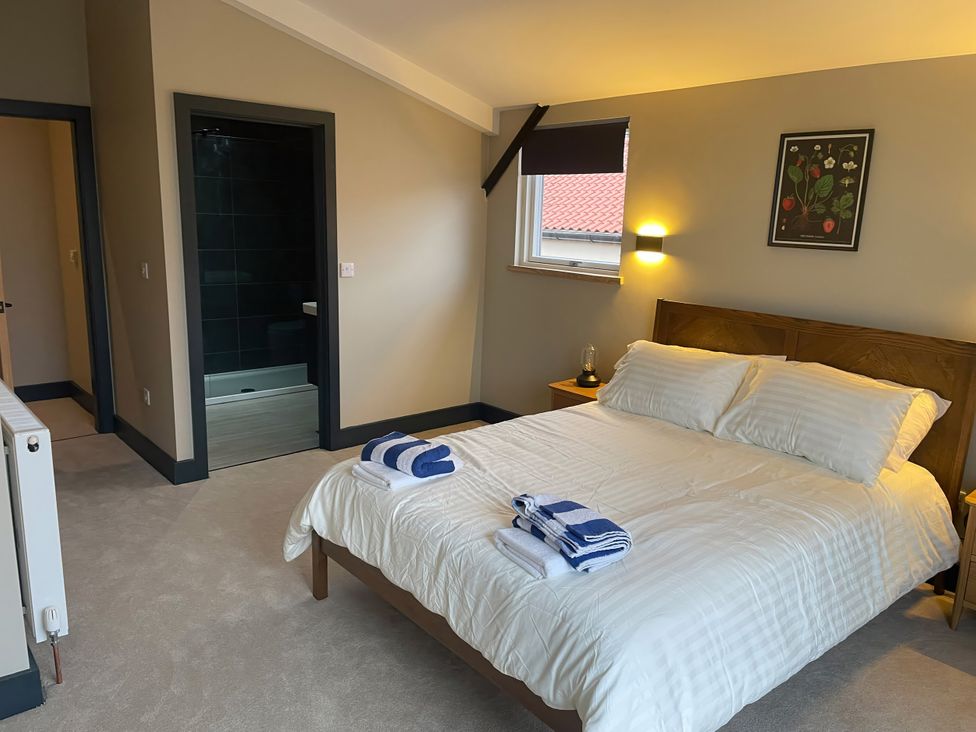 A bedroom with a bed and towels at Spring Meadow in Croxdale