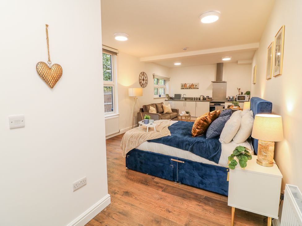 A studio room with a bed and sofa at 2 in Peterborough