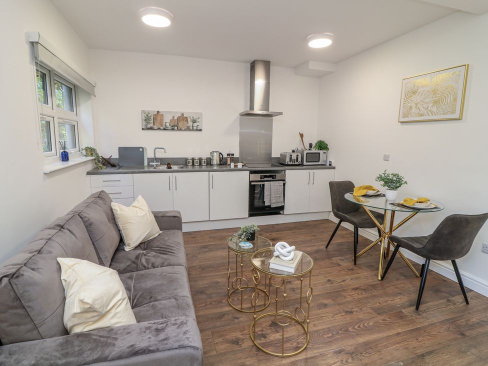 A kitchen with a sofa and dining table at 2, Peterborough