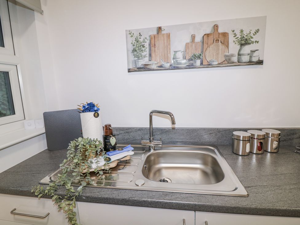 A kitchen counter with a sink and wall art at 2, Peterborough