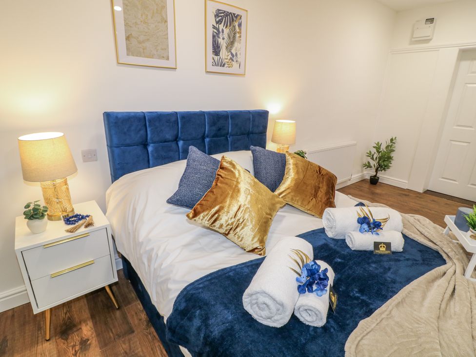A bedroom with bed and bedside table at 2 in Peterborough
