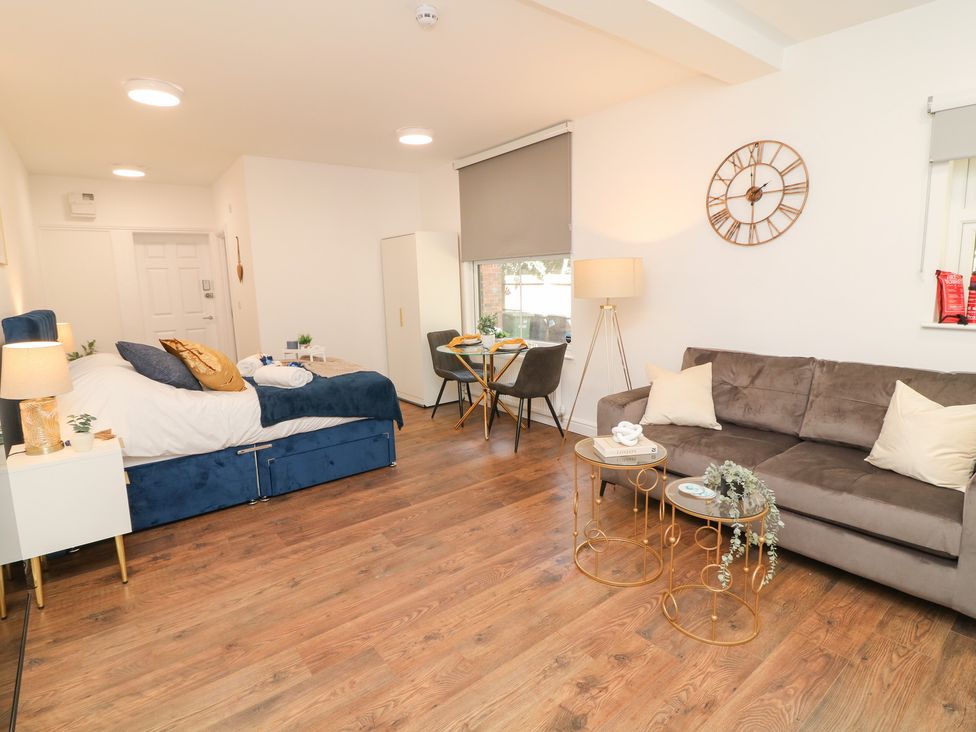 A living room with a bed and sofa at 2 in Peterborough