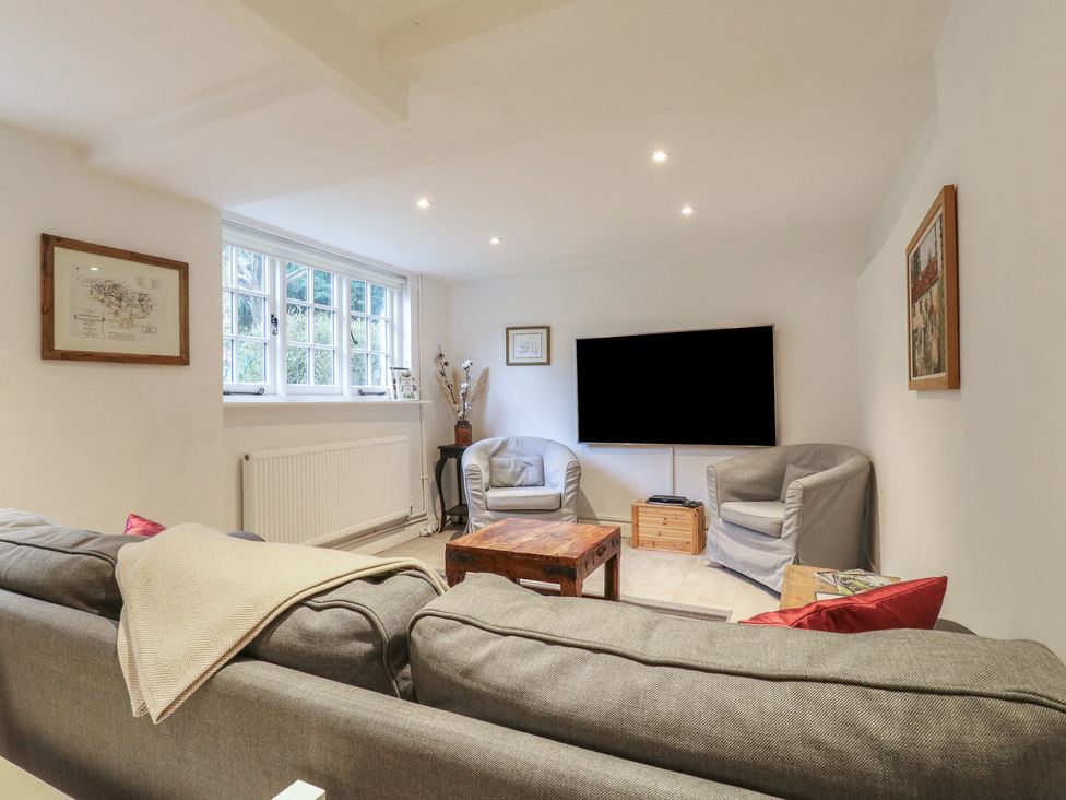 A living room with furniture including a sofa and television at Cherry Cottage
