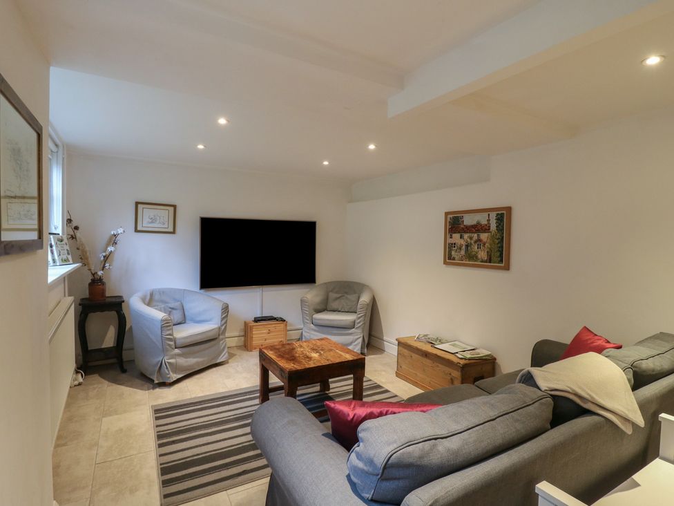 A living room with sofa and armchairs at Cherry Cottage